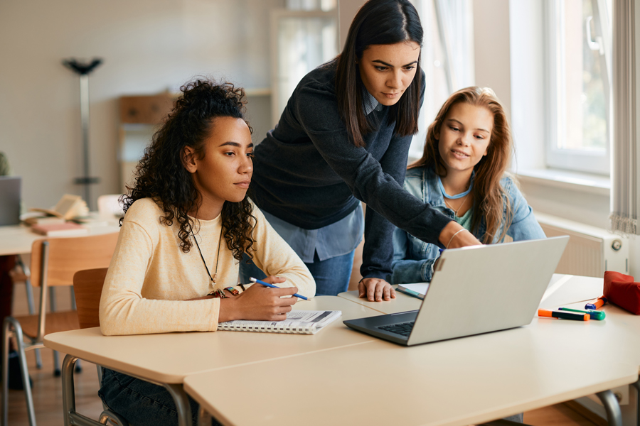 high-school-professor-assisting-her-students-in-e-2022-11-23-18-00-59-utc high-school-professor-assisting-her-students-in-e-2022-11-23-18-00-59-utc